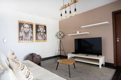 a living room with a white couch and a flat screen tv at Villa Ocean Sight by LovelyStay in Funchal