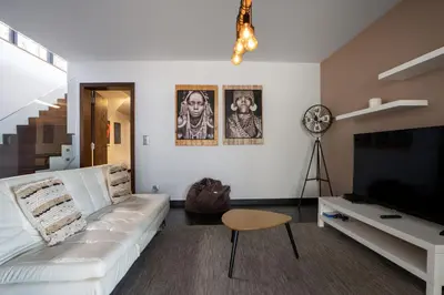 a living room with a white couch and a flat screen tv at Villa Ocean Sight by LovelyStay in Funchal