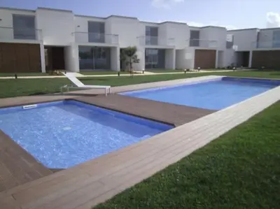 a large blue swimming pool in front of a house at Sea Sagres in Sagres
