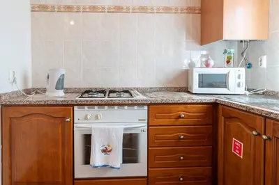 a kitchen with a stove and a microwave at Apartamento Isabel in Achada de Cima