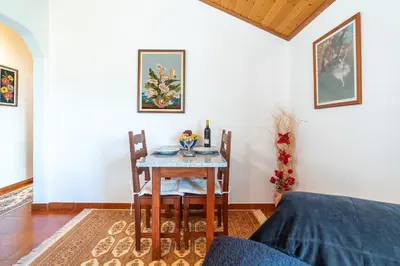 a dining room with a table and chairs at Apartamento Isabel in Achada de Cima