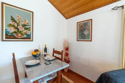 a small dining room with a table and chairs at Apartamento Isabel in Achada de Cima