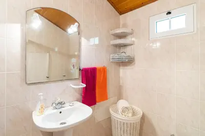 a bathroom with a sink and a mirror at Apartamento Isabel in Achada de Cima