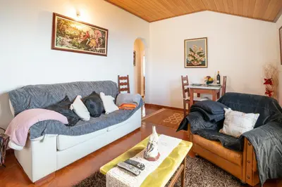 a living room with a couch and a chair at Apartamento Isabel in Achada de Cima