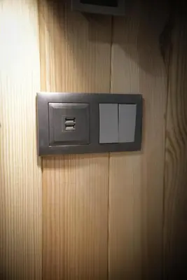 a lightswitch attached to a wooden wall at Machim House by AnaLodges in Machico