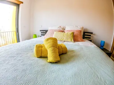 a stuffed animal is on top of a bed at Casa Mawi in Sagres