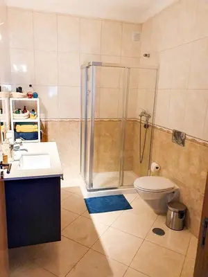 a bathroom with a shower and a toilet and a sink at Casa Mawi in Sagres