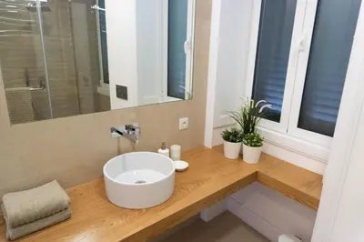 a bathroom with a white sink and a mirror at Superior Rentals - Downtown Villa in Funchal