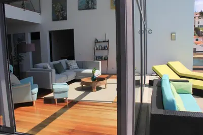 a living room with a couch and a table at Sea House Madeira in Garajau