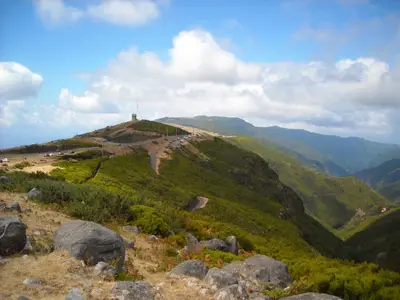 a hill with a cross on top of a mountain at Lucilia's House in Calheta