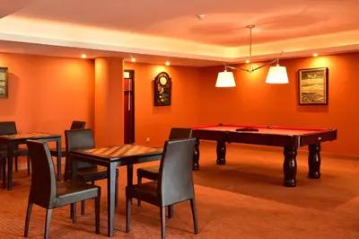 a room with a ping pong table and chairs at Pestana Promenade Ocean Resort Hotel in Funchal