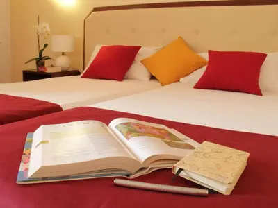 an open book sitting on top of a bed at Casa dos Serrões in Calheta