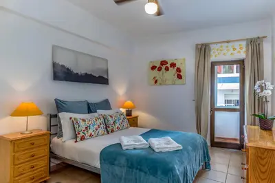 a bedroom with a bed with two towels on it at FLH Praia da Luz Apartment with Balcony in Luz
