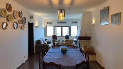 a living room with a couch with pillows at Casa do Miradouro in Carrapateira