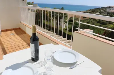 a bottle of wine sitting on a table on a balcony at Lagos Vila Mós 59 in Lagos
