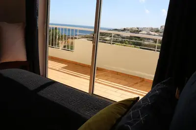 a bedroom with a balcony with a view of the ocean at Lagos Vila Mós 59 in Lagos
