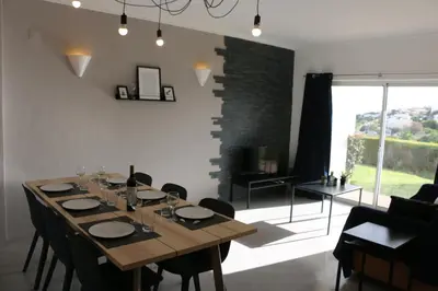 a dining room with a wooden table and chairs at Lagos Beach 59A in Lagos