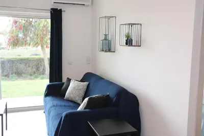 a blue couch in a living room with a window at Lagos Beach 59A in Lagos