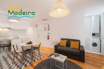 a staircase in a home with white walls and wood floors at OurMadeira - Heart of Old Town I in Funchal