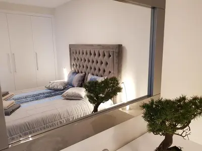 a mirror reflection of a bed in a room at Madalenas Palace - Sunrise in Funchal