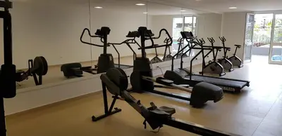 a gym with rows of treadmills and elliptical machines at Madalenas Palace - Sunrise in Funchal