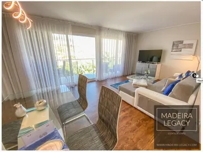 a living room with a couch and a table with chairs at Madalenas Palace - Sunrise in Funchal