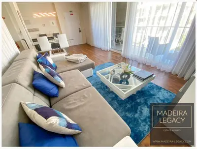 a living room with a couch and a table at Madalenas Palace - Sunrise in Funchal