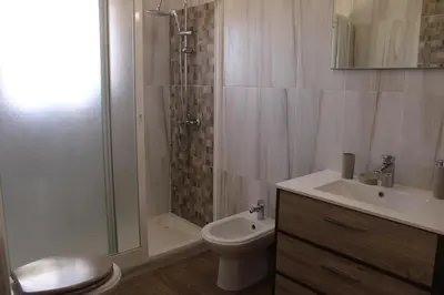 a bathroom with a shower and a toilet and a sink at Abrigo das Nortadas in Vila do Bispo