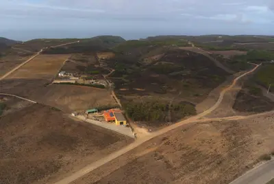 an aerial view of a dirt road in a field at Abrigo das Nortadas in Vila do Bispo