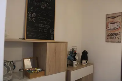 a kitchen with a chalkboard on the wall and a shelf at Abrigo das Nortadas in Vila do Bispo