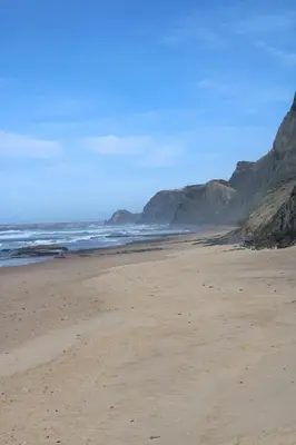 a sandy beach with rocks in the ocean at Abrigo das Nortadas in Vila do Bispo