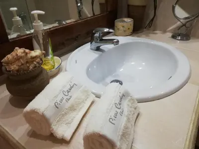 a bathroom sink with two folded towels on it at By the Beach & Pool Apartment in Funchal