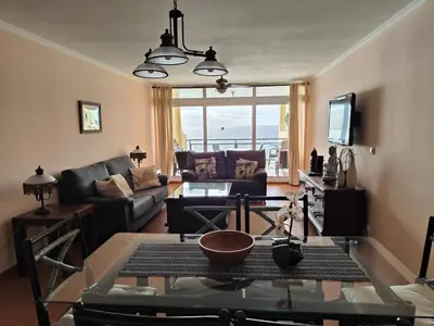 a living room with a couch and a table at By the Beach & Pool Apartment in Funchal