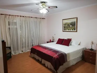 a bedroom with a bed and a ceiling fan at By the Beach & Pool Apartment in Funchal