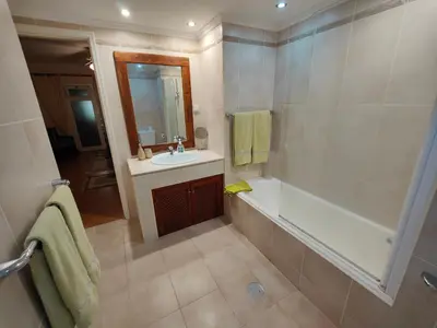 a bathroom with a tub and a sink and a shower at By the Beach & Pool Apartment in Funchal