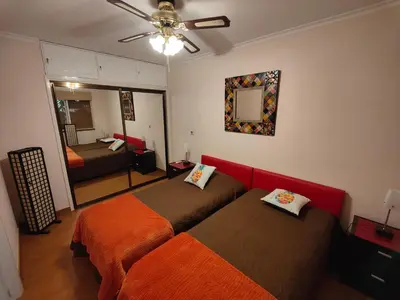 a bedroom with two beds and a mirror at By the Beach & Pool Apartment in Funchal