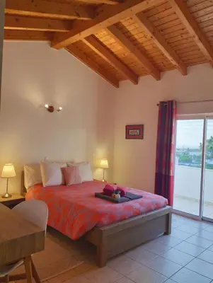 a bedroom with a bed and a large window at VILLA ANDORINHA with Private Pool in a quiet area in Aljezur