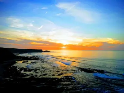 a sunset over the ocean with the sun setting at VILLA ANDORINHA with Private Pool in a quiet area in Aljezur