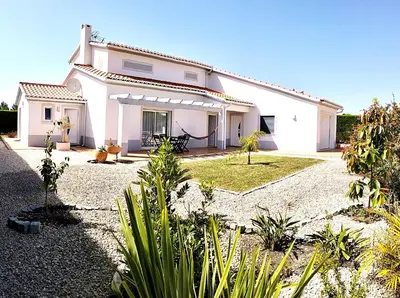 a white house with a garden in front of it at VILLA ANDORINHA with Private Pool in a quiet area in Aljezur