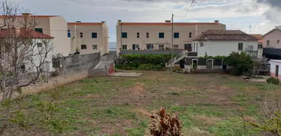 an empty yard with buildings in the background at Casa da Lagoa in Calheta