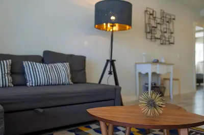 a living room with a couch and a table at Braganza apartment in Funchal