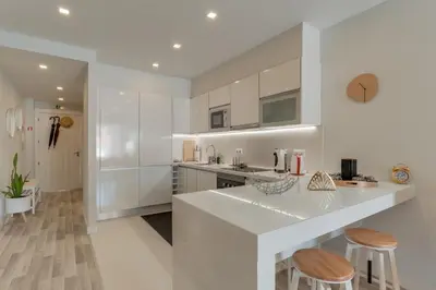 a kitchen with white cabinets and a white counter top at Braganza apartment in Funchal