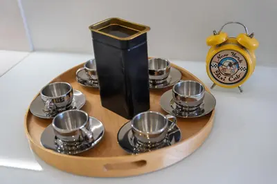 a tray with tea cups and a clock on a table at Braganza apartment in Funchal