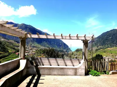 a bench sitting on top of a hill at Casa do Vale in São Vicente