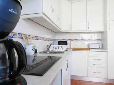 a kitchen with white cabinets and a sink at IM On Luz Arte in Luz