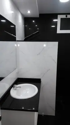 a bathroom with a white sink and a black counter at Vista Atlântico in Gaula