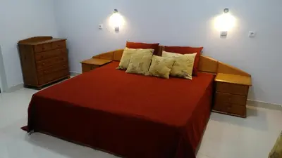 a bedroom with a large red bed with two night stands at Vista Atlântico in Gaula