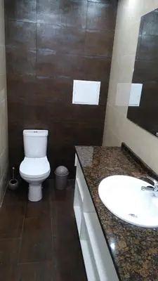 a bathroom with a white toilet and a sink at Vista Atlântico in Gaula