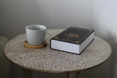 a table with a cup and a book and a coffee mug at The Best Atlantic Ocean View in Câmara de Lobos