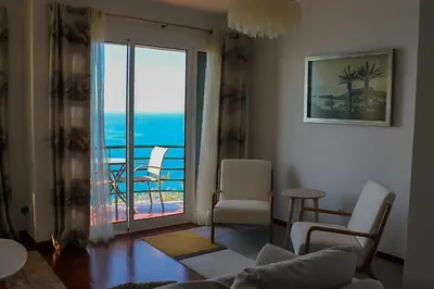 a living room with a view of the ocean at The Best Atlantic Ocean View in Câmara de Lobos